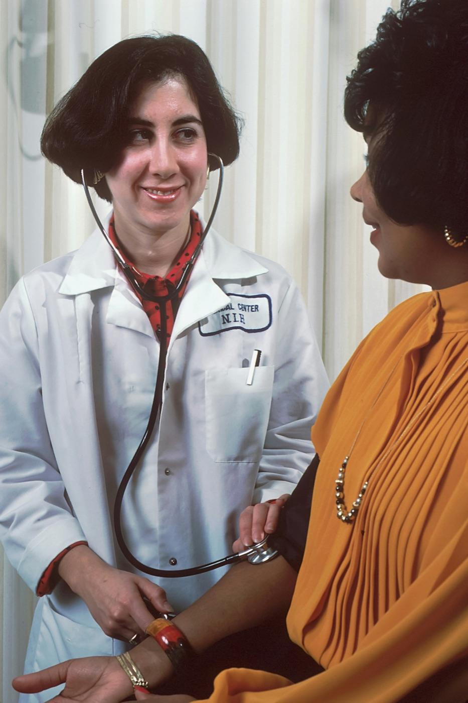 A doctor reassuring a patient during a consultation